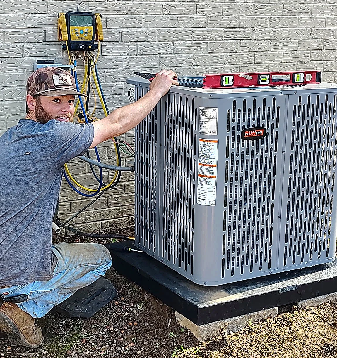 Glacier Heating & Air technician servicing an AC condenser in San Antonio